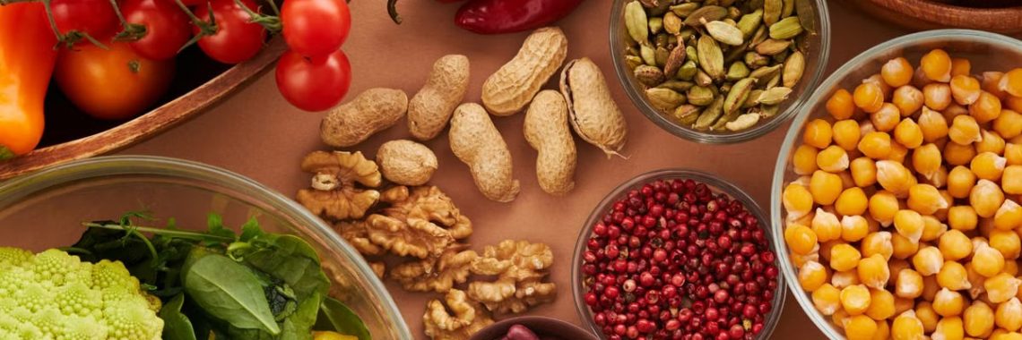 Explore a colorful assortment of healthy ingredients, featuring vegetables, nuts, seeds, and spices in a top view layout.